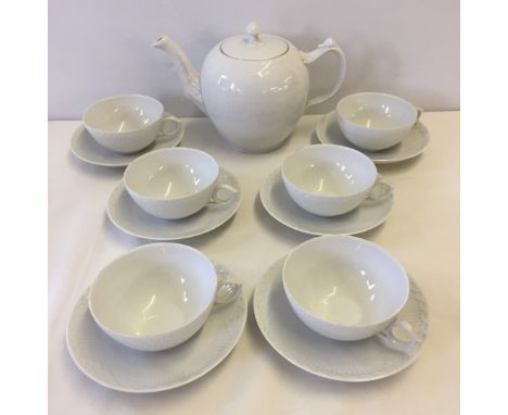 A Royal Copenhagen teapot with 6 cups & saucers. Half white lace pattern.  