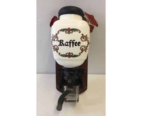 Vintage Dutch wall mounted coffee grinder with ceramic coffee bean container.  
