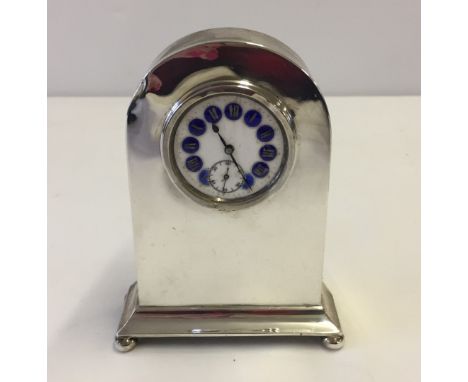 A hallmarked silver desk clock with enamelled dial. Birmingham 1920 by Walker & Hall. Movement needs repair and face a new gl