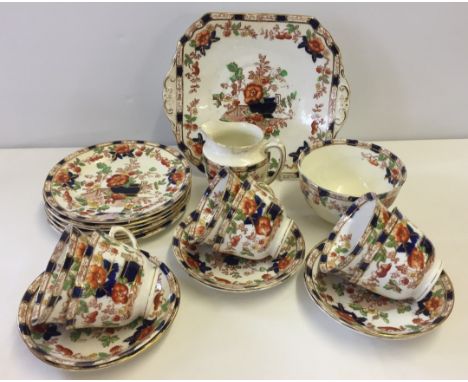 An early 20th Century china tea service. Sandwich plate, tea plates, cup saucers, sugar bowl and milk jug (a/f) 