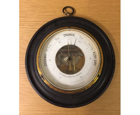 A vintage barometer on circular wooden mount. By C.W. Price, Bristol. 