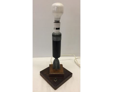 An electric table lamp made out of a dummy bomb.  