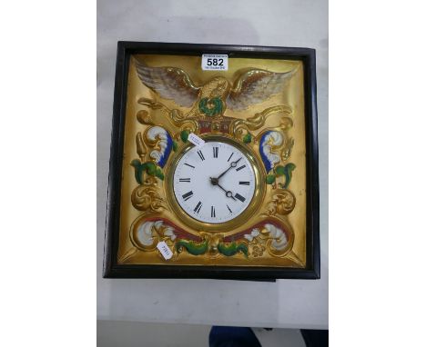 Continental framed wall clock with enamel dial and gilded face.
