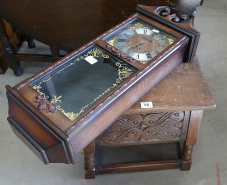 20th Century carved oak open top stool, with reproduction wall clock.