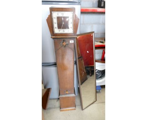Oak cased Art Deco clock and a large rectangular framed wall hanging mirror. (2)