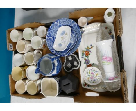 A mixed collection of ceramic items to include commemorative mugs, Copeland Spode flow blue water jug, Wedgwood money boxes e