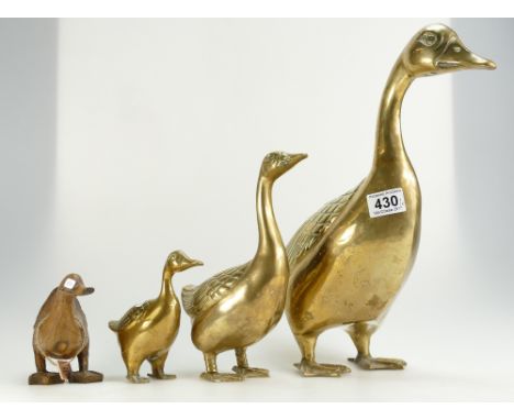 A collection of graduated brass ducks together with similar wooden item. (4)