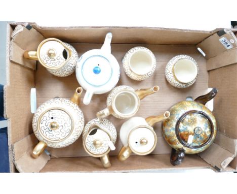 A collection of Sudlows cream and gold decorated tea pots, water jugs, sugar bowls, together with similar floral decorated te