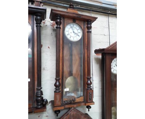 A weight driven walnut Vienna wall clock. 
