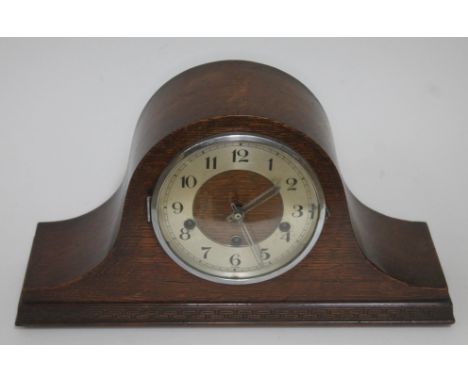 A domed oak mantel clock, length 42cm. 
