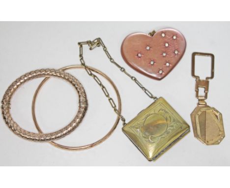 A mixed lot including a gilt bangle marked '925', a yellow metal bangle, a silver plated purse, a heart shaped pendant etc. 