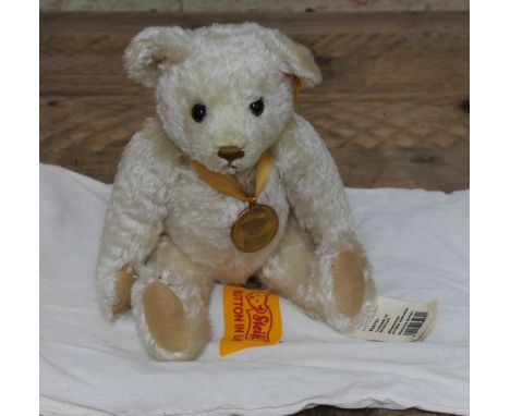 A Steiff Millenium mohair teddy bear with Danbury mint pendant. 