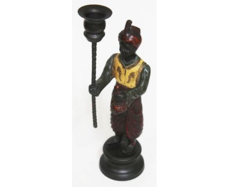 An eastern cast metal figural candlestick, height 29cm. 