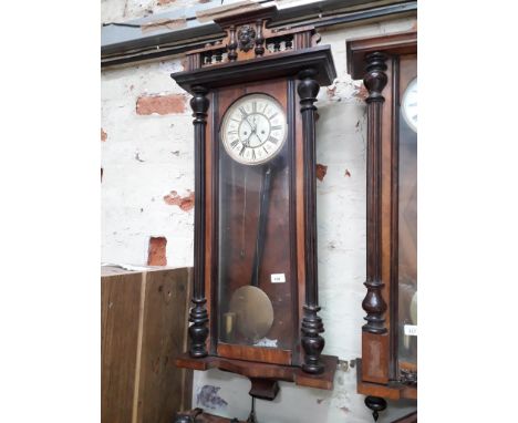 A weight driven walnut Vienna wall clock. 