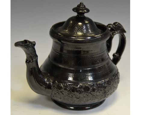 A 19th Century Jackfield teapot, moulded with foliage c 1820