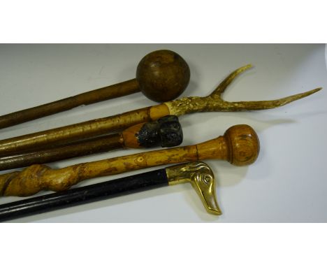 An early 20th century knobkerrie ; an antler hafted thumb stick; others etc 