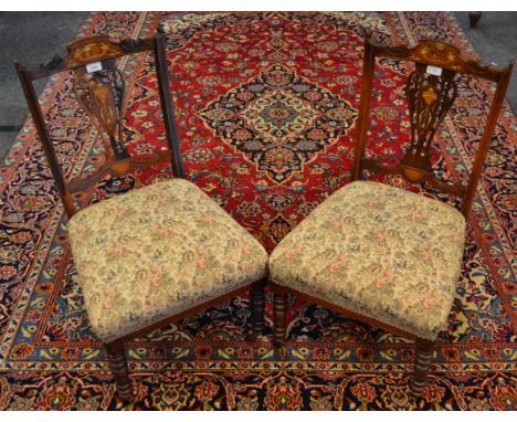 A pair of Edwardian Sheraton revival nursing chairs, satinwood inlaid, pierced splat, turned legs, ceramic casters, circa 190