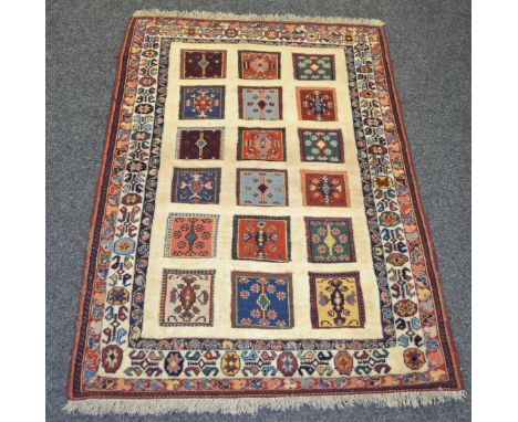 A Sozani rug, the madder field inset with 3 rows of Kilim carpet, conforming borders 122cm x 85cm