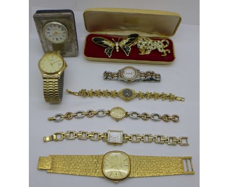 A small silver fronted clock, lady's and gentleman's wristwatches, including three Rotary, and two brooches 