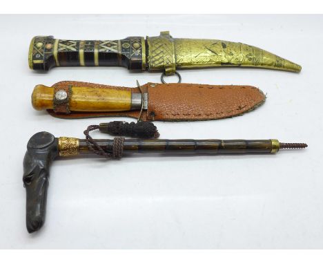An inlaid Jambyia dagger, a Swedish knife and a carved horn umbrella handle in the form of a greyhound's head 