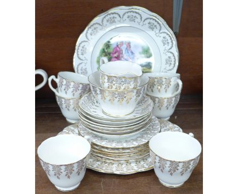 A twenty-one piece 22ct gold painted tea service and two plates 