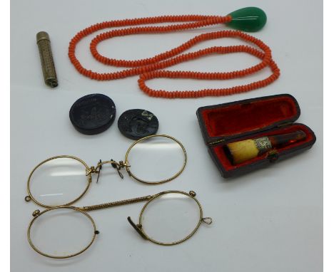 A string of coral beads with a jade pendant, two Pinz Nez spectacles, a Victorian cheroot holder and two seals 