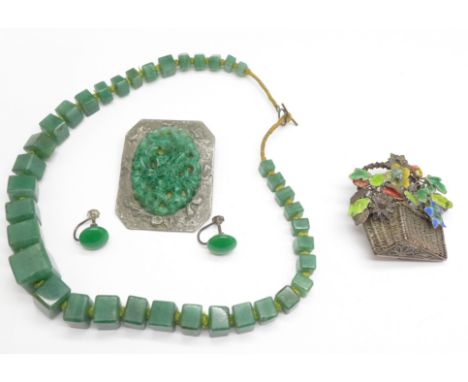 A Chinese silver and enamel flower basket brooch, a jade coloured necklace and earrings, and a carved pewter mounted brooch 