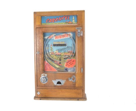 A 1950s Vertical 1d-in-the-slot Bagatelle Game ‘Carousel’, made by Parker’s Automatic Supplies, Rhyl, in varnished light wood