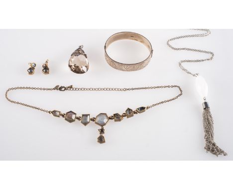 A small mixed group of jewellery, including a 1970's hinged silver bangle with foliate and textured engraving to front panel,