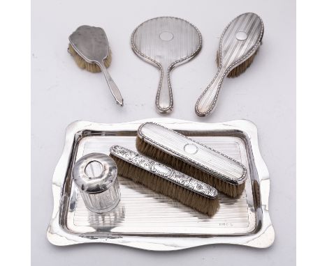 A George V silver dressing table set by Kimberley & Hewitt Ltd, Birmingham 1928; comprising of rectangular tray with wavy rim