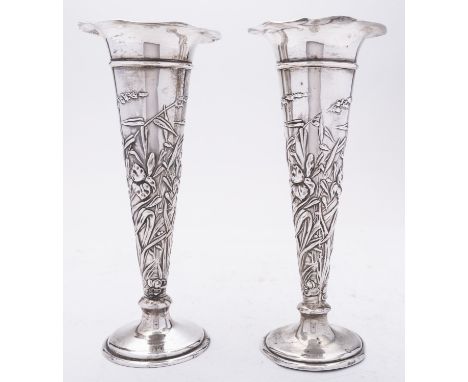 A pair of Edward VII silver trumpet vases by William Comyns, London 1903, decorated with Iris's and grasses, loaded flared ba