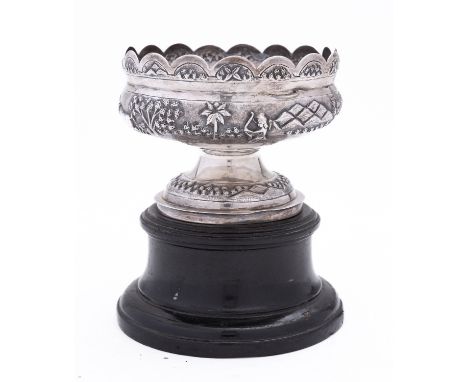 An Indian silver bowl by Mondhuden Bhowanipore Calcutta marked on the base, the wavy rim above an embossed decorated scene of