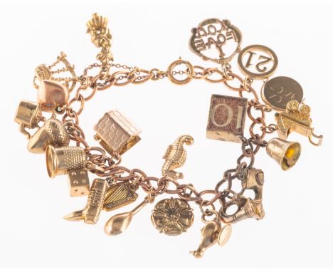 A charm bracelet with charms, a curb link charm bracelet with bolt ring closure and safety chain, the majority of links are m
