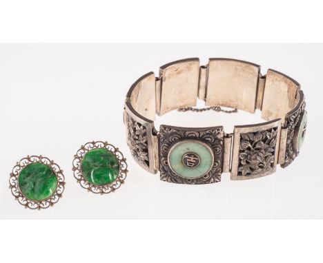 A pair of jade earrings and a jade set bracelet, a pair of stud earrings, each set with circular carved jade with an openwork