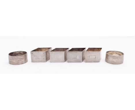 A set of four Art Deco silver napkin rings by Henry Bushell & Co, Birmingham 1936, of rhombus form with engine turned decorat
