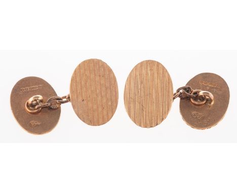 A pair of 9ct rose gold cufflinks, of oval form with engine turned engraving to both panels, chain link fitting, 5.0grams.