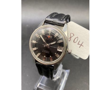 A gents Orient black faced wrist watch with seconds sweep and date aperture W/O