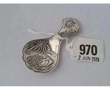 An unusual Eastern caddy spoon the bowl embossed with a figure and a palm tree, the back stamped NIEUWPOORT
