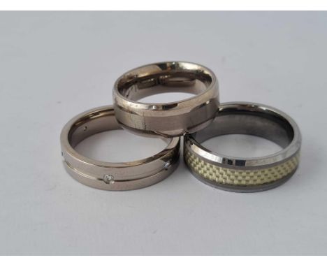 Two titanium and one tungsten band rings