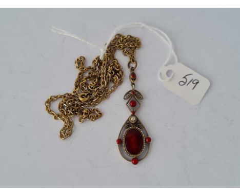 A silver and red enamel pendant on chain