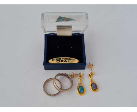 A pair of silver and opal earrings and two silver rings