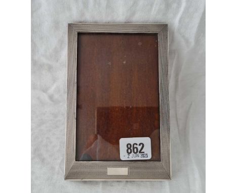 A good rectangular photo frame with engine turned boarder, easel back, 6.5" high, Birmingham 1937 by S&amp;M