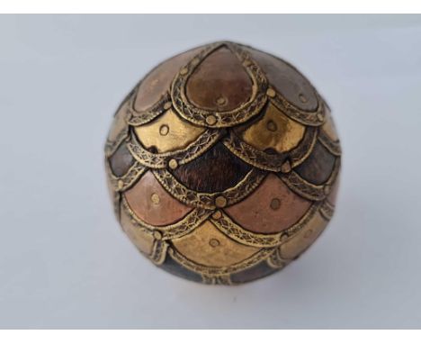 An unusual copper and other metal item in the form of a cricket ball