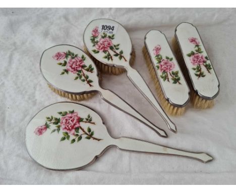 An attractive enamel decorated five piece dressing table set with plated mounts