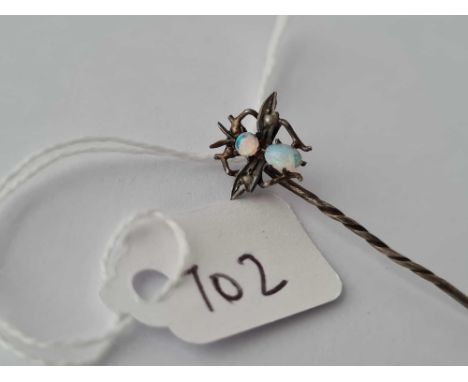 An opal and pearl metal stick pin with bug terminal