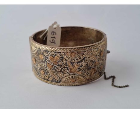 Good very wide silver bangle with floral decorations with gold overlay