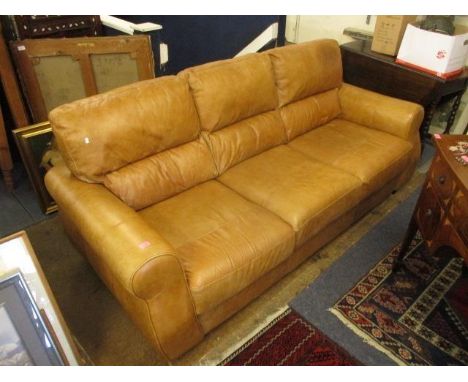 A tan brown soft leather three seater sofa 