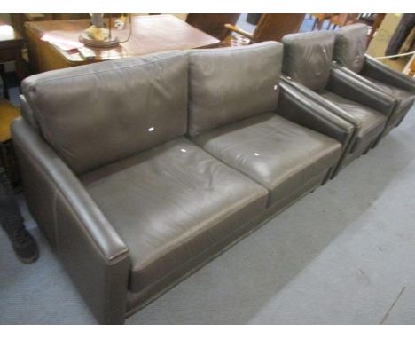 A two seater leather sofa and two armchairs 