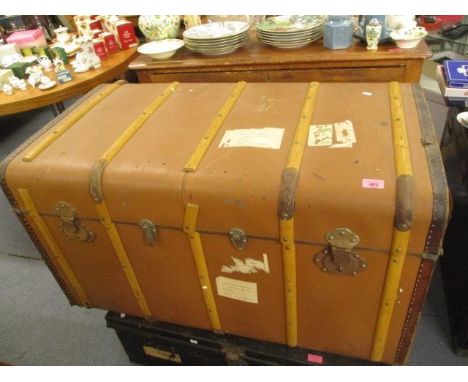 A vintage wooden and iron bound steamer trunk 