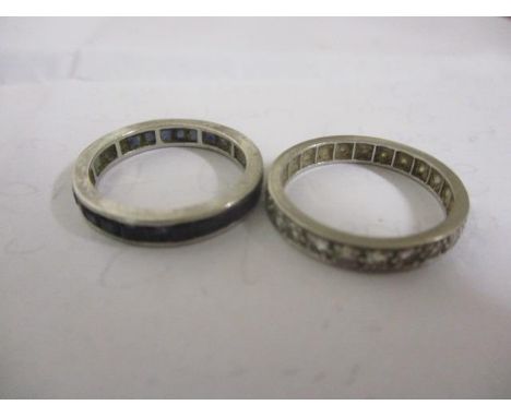 Two white metal eternity rings to include a sapphire ring and a diamond ring 